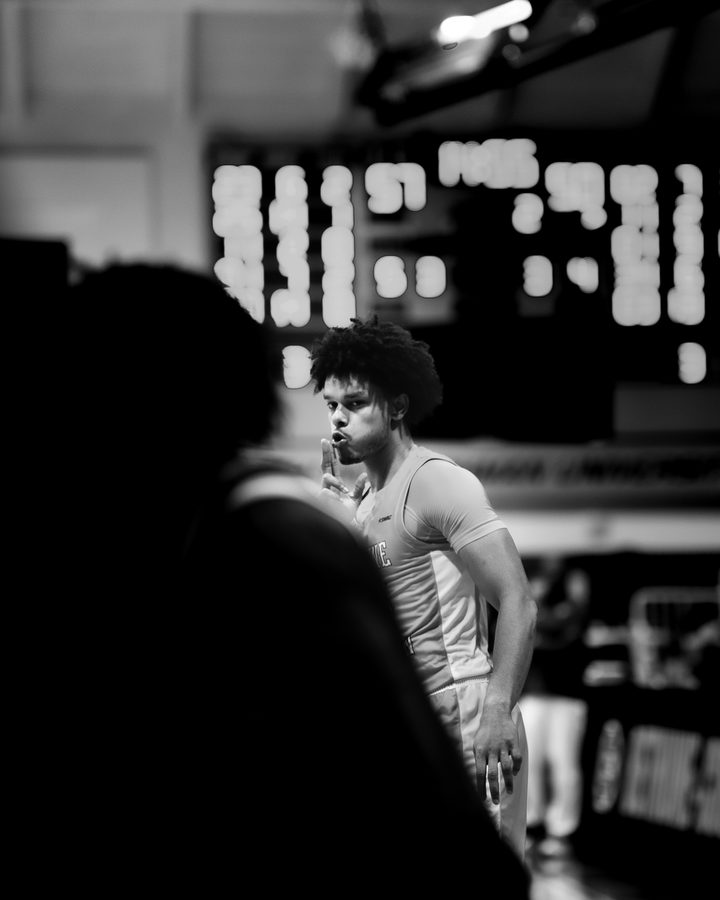 BCU Basketball — dramatic player under red and yellow arena lights